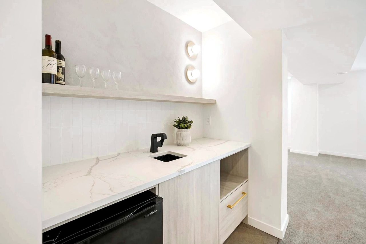Finished legal basement suite kitchenette in an Edmonton home with quartz counter and bar fridge