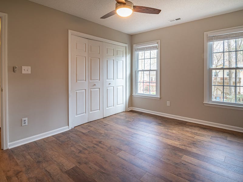 Newly installed wide-plank hardwood flooring in a bright renovated room