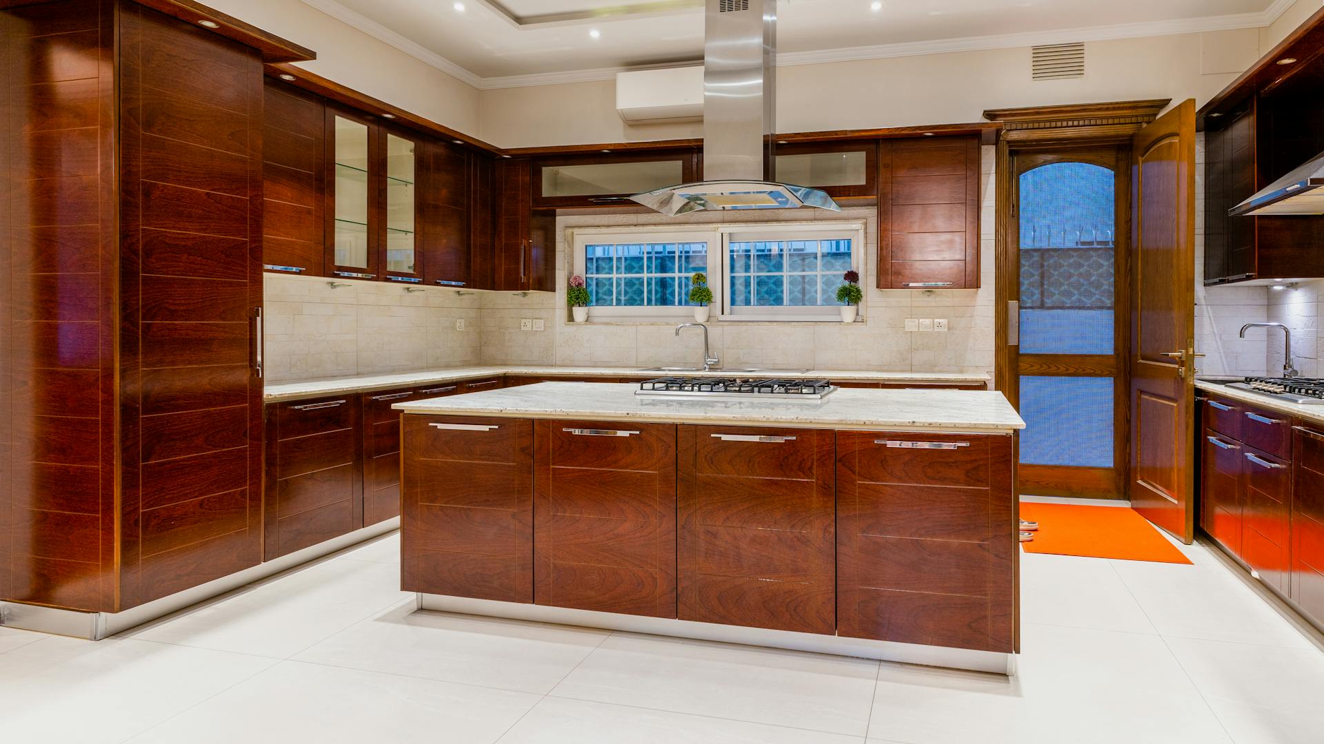 Bright, renovated open-concept kitchen with custom wood cabinetry and a large island